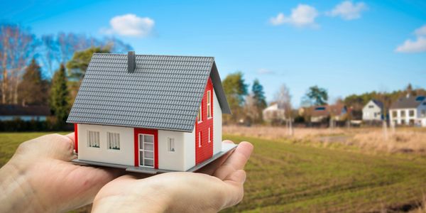 Miniature house model held in hands